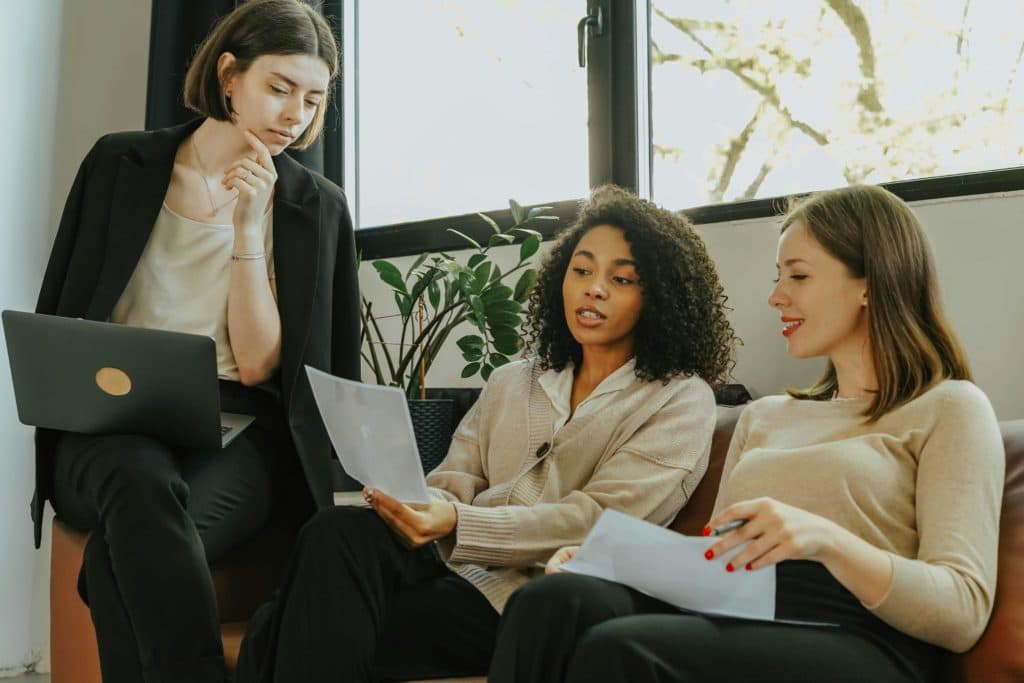 Three people in a discussion at an office